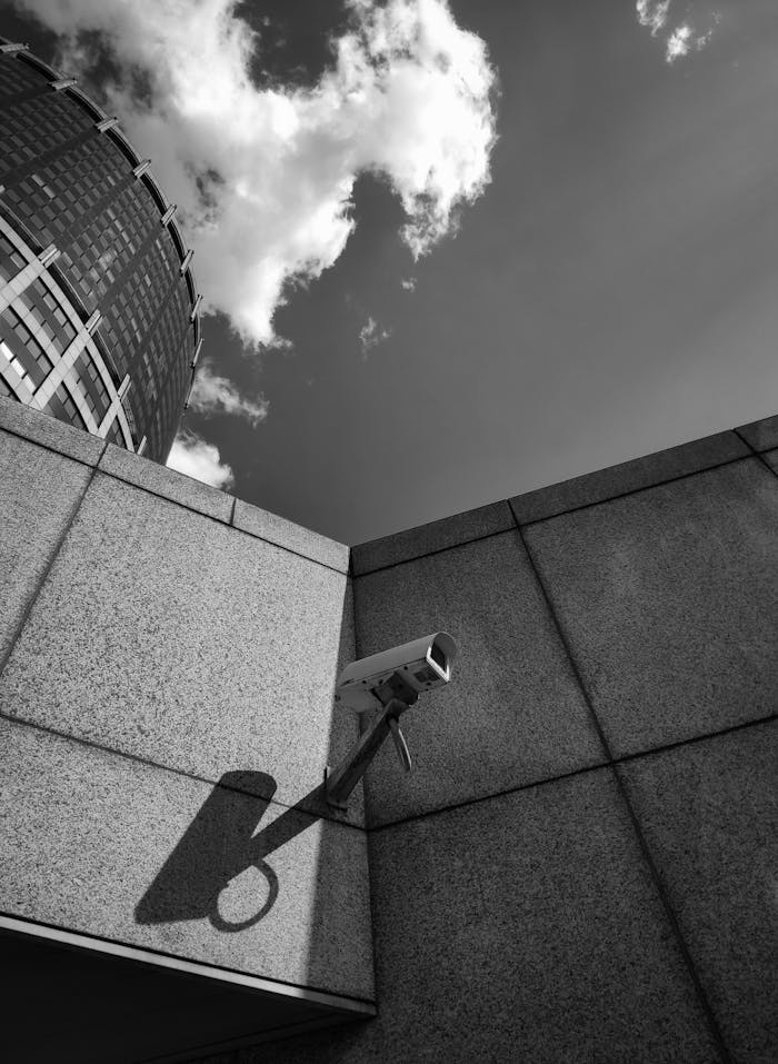 Grayscale Photography of Concrete Wall with Security Camera